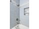Stylish shower area with blue tiling, a niche for toiletries, and modern fixtures at 624 E Walnut St # 46, Indianapolis, IN 46204