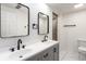 Modern bathroom featuring double sink vanity, black hardware and elegant mirrors at 660 Sun Valley Ct, Indianapolis, IN 46217