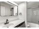 Bright bathroom featuring a modern vanity with matte black faucet and a shower with sliding glass doors at 660 Sun Valley Ct, Indianapolis, IN 46217