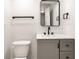 Modern bathroom featuring sleek gray vanity, black fixtures and a minimalist design at 660 Sun Valley Ct, Indianapolis, IN 46217