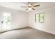 Bright bedroom featuring a ceiling fan, large window and a walkout balcony at 660 Sun Valley Ct, Indianapolis, IN 46217