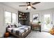 Stylish bedroom featuring a cozy bed, desk, shelves and decor, complemented by a ceiling fan and natural light at 660 Sun Valley Ct, Indianapolis, IN 46217