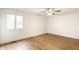 Bedroom with laminated flooring, ceiling fan, and bright windows providing ample natural light at 660 Sun Valley Ct, Indianapolis, IN 46217