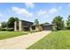 Charming stone and siding home with well-maintained lawn and long driveway leading to the garage at 660 Sun Valley Ct, Indianapolis, IN 46217