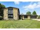 Inviting two-story stone home featuring a balcony, manicured lawn, and attached garage at 660 Sun Valley Ct, Indianapolis, IN 46217