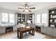 Spacious home office featuring custom built-in shelving, a large wooden desk and large windows, promoting productivity and focus at 660 Sun Valley Ct, Indianapolis, IN 46217