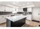 Well-lit kitchen with white cabinets, subway tile backsplash, and an island at 660 Sun Valley Ct, Indianapolis, IN 46217