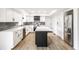 Beautiful kitchen with white cabinets, stainless steel appliances, and a black island at 660 Sun Valley Ct, Indianapolis, IN 46217
