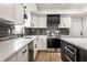 Gorgeous kitchen featuring white cabinets, stainless steel appliances, and dark backsplash at 660 Sun Valley Ct, Indianapolis, IN 46217