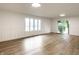 Bright living room with hardwood floors, panelled walls, sliding glass door, and ample natural light at 660 Sun Valley Ct, Indianapolis, IN 46217