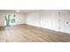 Open living room with wood flooring, access to the backyard, white walls, and closet at 660 Sun Valley Ct, Indianapolis, IN 46217