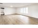 Bright, open living room with beautiful wood-look floors and natural light from large windows at 660 Sun Valley Ct, Indianapolis, IN 46217