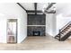Living space featuring a stone fireplace, staircase, and stainless steel refrigerator at 660 Sun Valley Ct, Indianapolis, IN 46217
