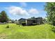 Siding house with a spacious backyard, mature tree, and neighbors house in the background at 660 Sun Valley Ct, Indianapolis, IN 46217