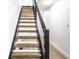 Modern staircase with wooden steps and black metal railings adds a touch of elegance to the home at 660 Sun Valley Ct, Indianapolis, IN 46217
