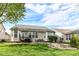 A beautiful backyard with lush green grass, outdoor dining area, and a charming fire pit at 6625 W Winding Bnd, McCordsville, IN 46055