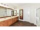 Bathroom showcasing double sinks, wooden cabinets, and a walk-in shower at 6625 W Winding Bnd, McCordsville, IN 46055