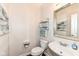 Bathroom featuring a sink, toilet and a mirror with decorative elements at 6625 W Winding Bnd, McCordsville, IN 46055