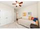 Bright bedroom showcasing neutral walls, a ceiling fan, and comfortable bed at 6625 W Winding Bnd, McCordsville, IN 46055