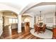 Open dining area with wood table, chairs, hardwood floors, and elegant lighting at 6625 W Winding Bnd, McCordsville, IN 46055