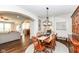 A spacious dining room, adjacent to other rooms, with seating for six at 6625 W Winding Bnd, McCordsville, IN 46055