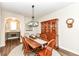 Comfortable dining area with hardwood floors, round rug, hutch and modern light fixture at 6625 W Winding Bnd, McCordsville, IN 46055