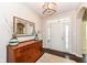 Inviting foyer featuring a wooden console table, mirror, and light hardwood floors at 6625 W Winding Bnd, McCordsville, IN 46055