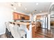 Charming kitchen with wooden cabinets, stainless steel appliances, and bar seating area at 6625 W Winding Bnd, McCordsville, IN 46055