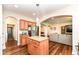 Open-concept kitchen with stainless steel refrigerator leading to the living room at 6625 W Winding Bnd, McCordsville, IN 46055