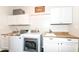 Functional laundry room with appliances, ample counter space, and storage cabinets at 6625 W Winding Bnd, McCordsville, IN 46055