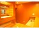 Wet bar area with hardwood flooring, glass shelving, sink, tile backsplash, and wooden cabinets at 6725 Tramcus Dr, Indianapolis, IN 46260