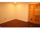 Basement features hardwood flooring, a door, and bright, neutral walls at 6725 Tramcus Dr, Indianapolis, IN 46260