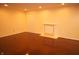 Finished basement features hardwood flooring, recessed lighting, and a tiled decorative fireplace at 6725 Tramcus Dr, Indianapolis, IN 46260