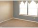 A light-filled bedroom with carpet and neutral walls with natural light at 6725 Tramcus Dr, Indianapolis, IN 46260