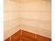 Well-organized closet with multiple shelves and hardwood floors providing ample storage space at 6725 Tramcus Dr, Indianapolis, IN 46260