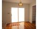 A sunlit dining area features a sliding glass door that allows natural light, and gorgeous hardwood floors at 6725 Tramcus Dr, Indianapolis, IN 46260