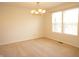Well-lit dining room features neutral paint, plush carpeting and a decorative light fixture at 6725 Tramcus Dr, Indianapolis, IN 46260