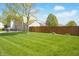 A lush lawn and mature trees enhance this home's curb appeal and natural setting at 6725 Tramcus Dr, Indianapolis, IN 46260