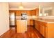 Kitchen featuring wood cabinets, stainless steel appliances, hardwood floors, and a center island for meal preparation at 6725 Tramcus Dr, Indianapolis, IN 46260