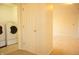 A white door opens to the laundry room with a washer and dryer at 6725 Tramcus Dr, Indianapolis, IN 46260