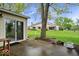 Expansive backyard featuring a patio, mature trees, and lush green lawn at 7424 Prairie Lake Dr, Indianapolis, IN 46256