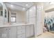 Bright bathroom with a double sink vanity, large mirror, and white fixtures at 7424 Prairie Lake Dr, Indianapolis, IN 46256