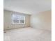 Bright bedroom with neutral walls, carpet flooring, and a large window at 7424 Prairie Lake Dr, Indianapolis, IN 46256