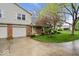 Charming brick home with well-maintained landscaping and an attached two-car garage at 7424 Prairie Lake Dr, Indianapolis, IN 46256