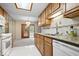 Traditional kitchen with granite countertops, stainless steel sink, and light wood cabinets at 7424 Prairie Lake Dr, Indianapolis, IN 46256