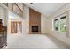 Open-concept living room with a soaring ceiling, fireplace, and seamless flow to the dining area at 7424 Prairie Lake Dr, Indianapolis, IN 46256