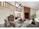 Bright living room features a soaring ceiling, brick fireplace, and seamless flow to dining area at 7424 Prairie Lake Dr, Indianapolis, IN 46256