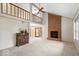 Bright living room features a soaring ceiling, brick fireplace, and seamless flow to dining area at 7424 Prairie Lake Dr, Indianapolis, IN 46256