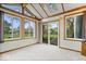 Bright sunroom with vaulted ceilings, many windows, and sliding glass door at 7424 Prairie Lake Dr, Indianapolis, IN 46256