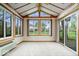 Bright sunroom featuring many windows, wood trim, and an attached AC unit at 7424 Prairie Lake Dr, Indianapolis, IN 46256